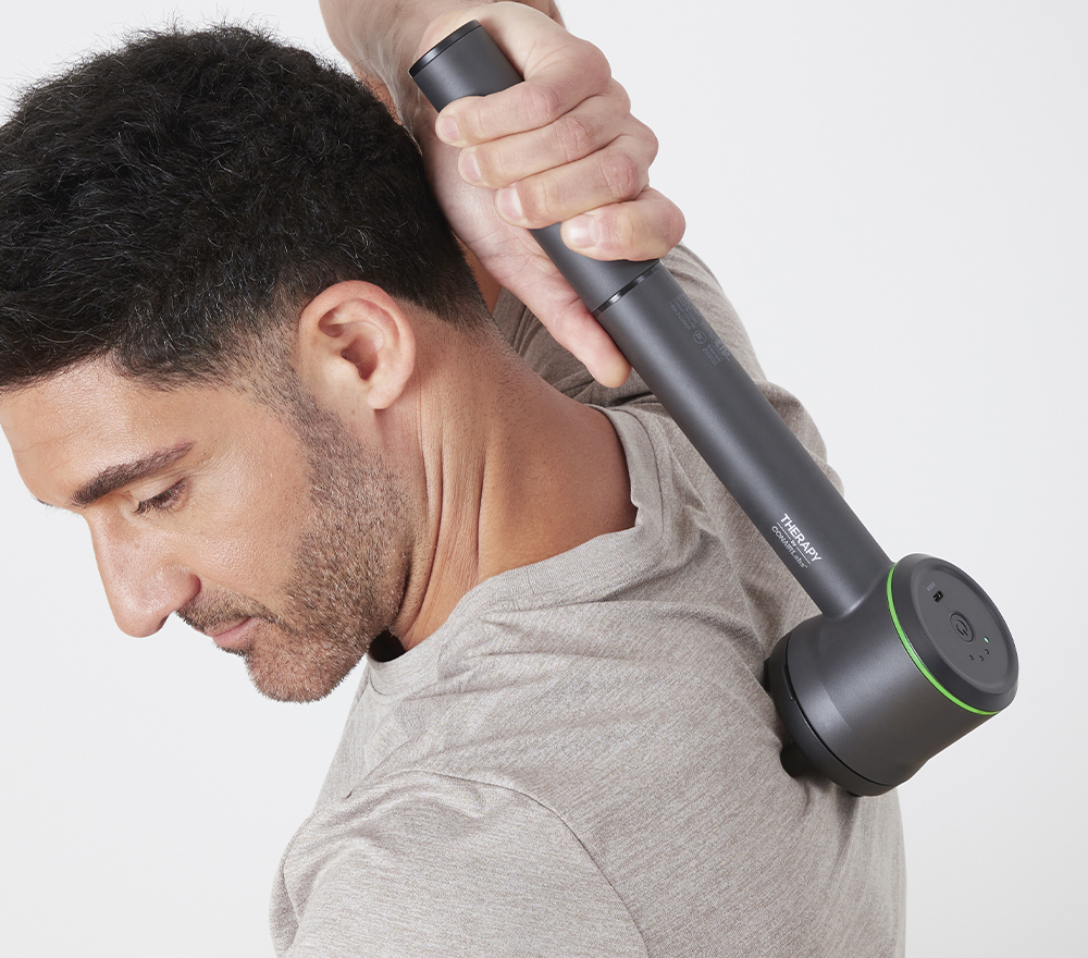 Man using massager on back